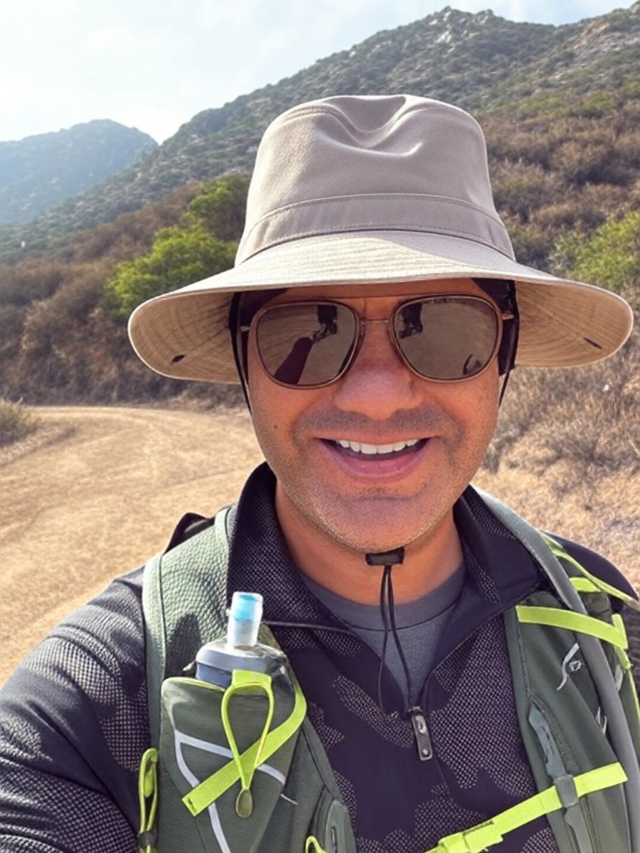 Peter smiling on a hiking trail in the hills
